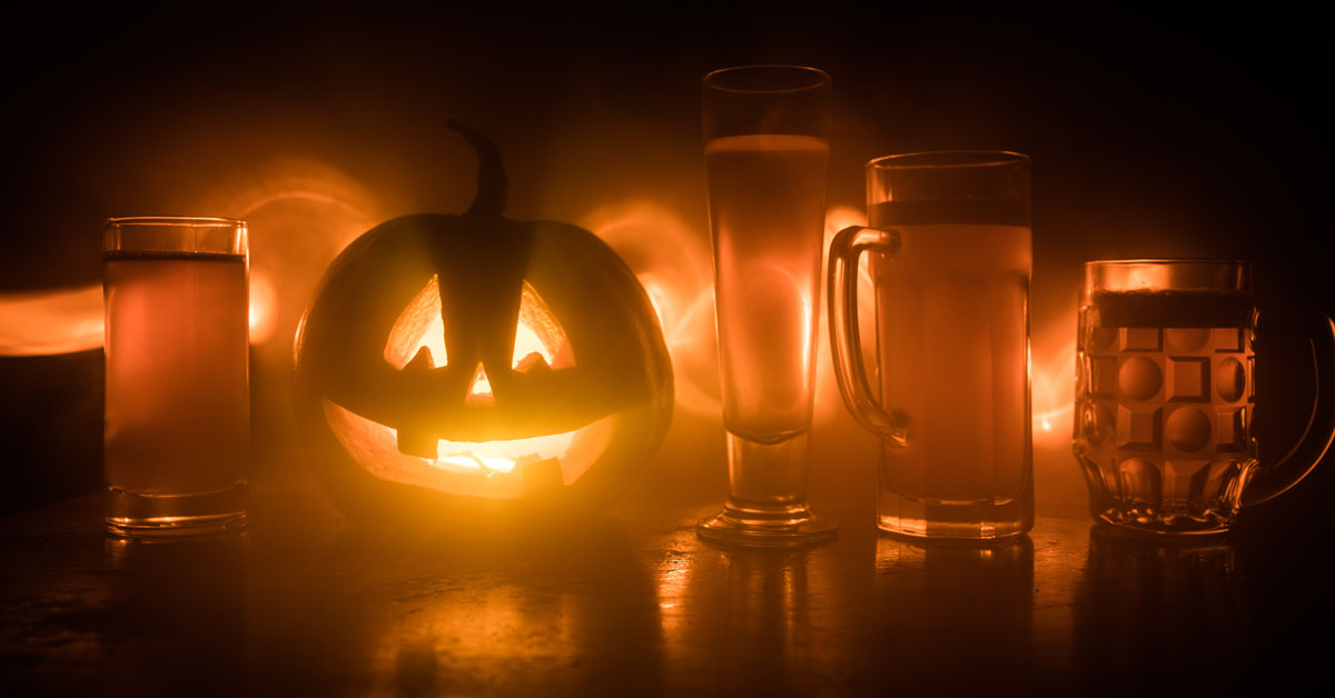 halloween carved pumpkin and craft beer spooky scene