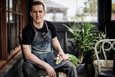 chef holding fresh scallions