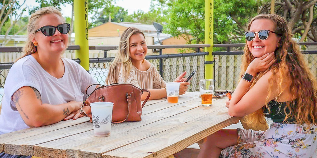 women enjoying beers on brewery patio