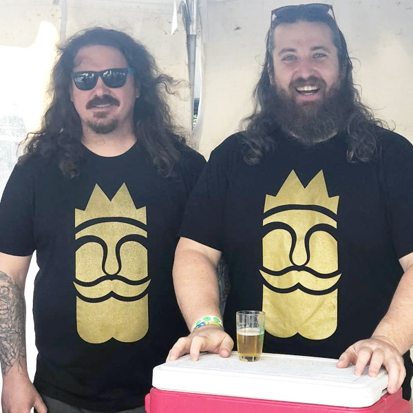 two brewery employees under tent with beer sample