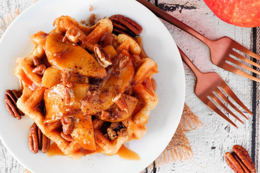 waffles topped with apples and caramel sauce