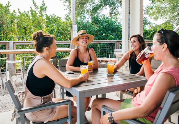 women enjoying beer in summer on taproom patio