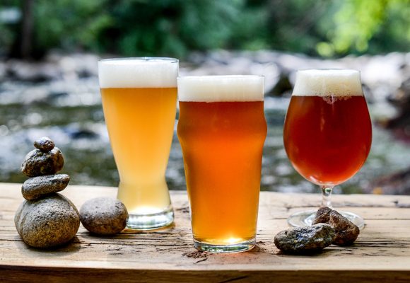 ales with stacked rocks against beautiful stream in nature