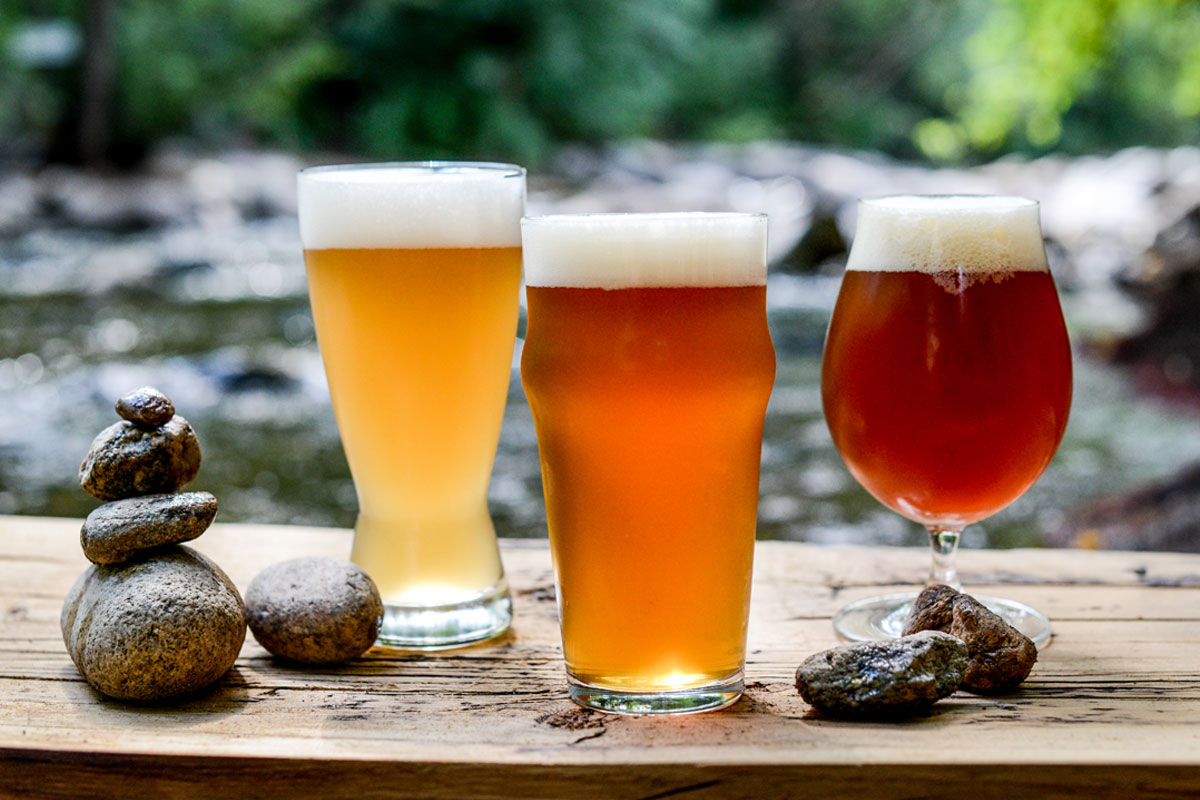 ales with stacked rocks against beautiful stream in nature