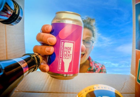 woman pulling beer out of box of beers