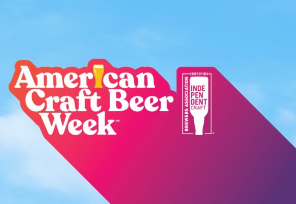 american craft beer week logo against blue sky background