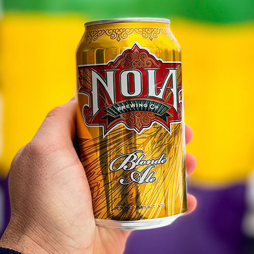 hand holding nola blonde ale can