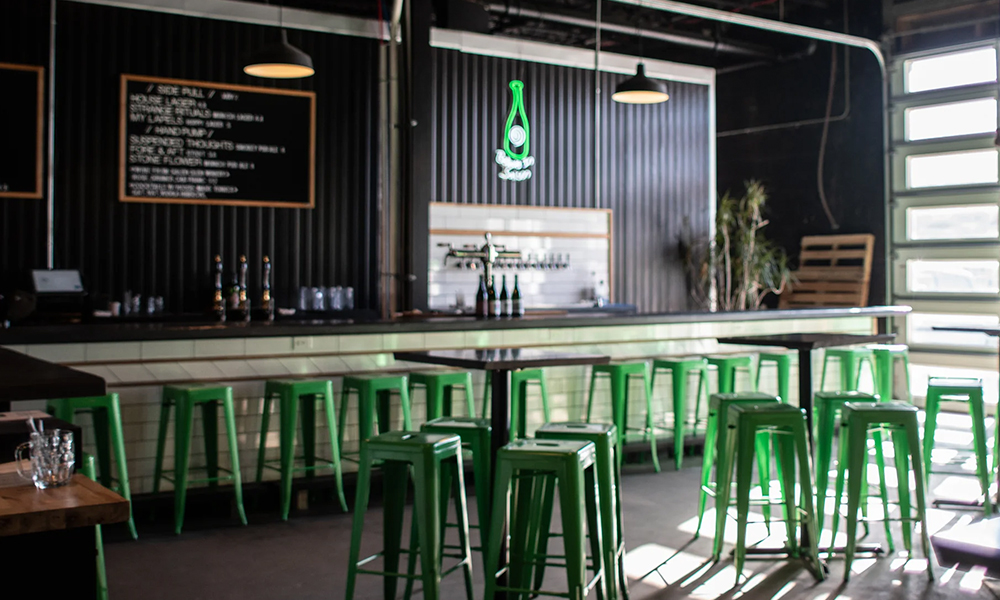 forest and main taproom interior with green bar stools