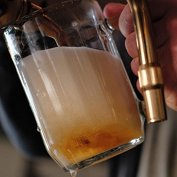 foam and beer in glass from fresh draught