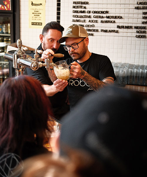 pouring pilsner in busy taproom