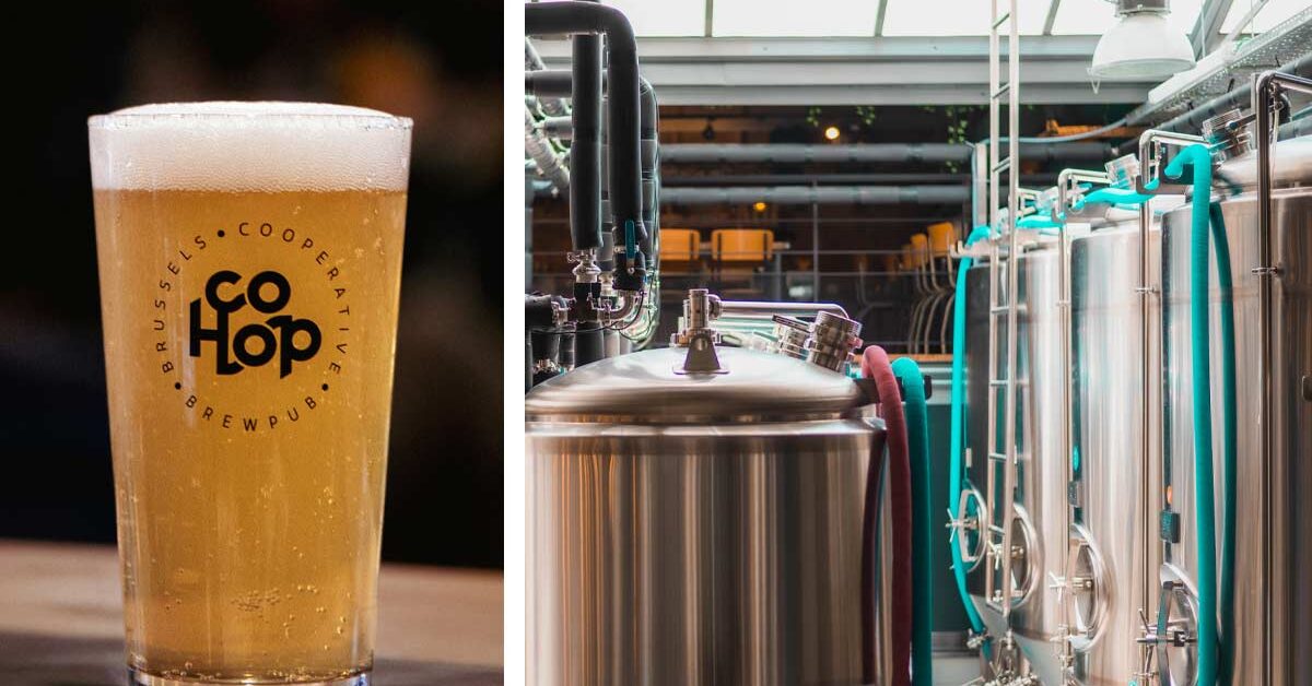 a freshly poured beer set on a table next to the brewhouse tanks