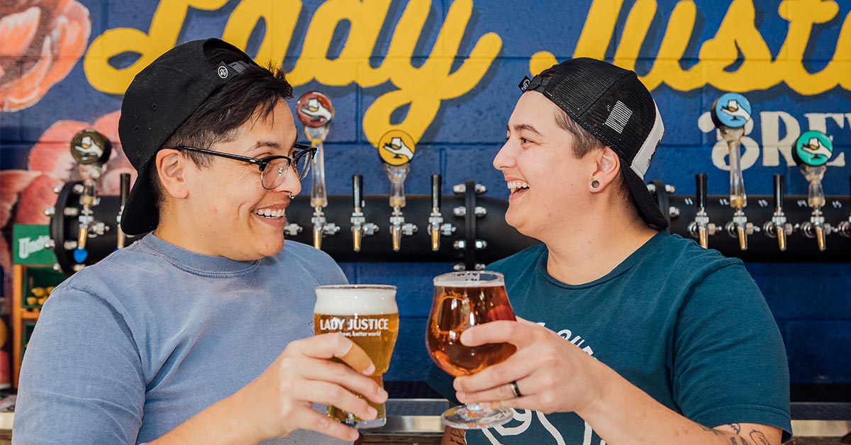 People smiling with beer glasses
