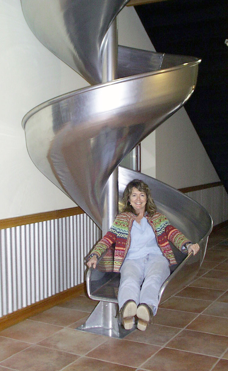 Kim Jordan ends a quick trip down a spiral slide at the New Belgium Fort Collins facility. The slide remains in place to this day. (Credit: New Belgium Brewing)